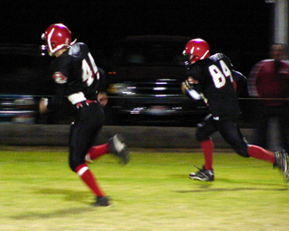 Sean Daly runs back a kickoff with an escort from Dan Enneking.